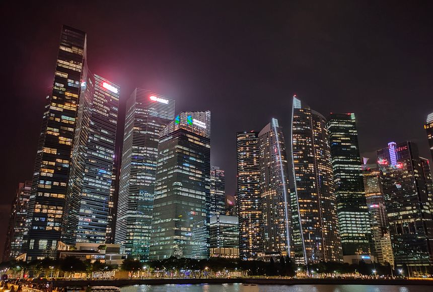 Singapore - January 20, 2025: Skyscrapers of many big banks with their logos at night are the DBS Bank and HSBC bank at Singapore on January 20, 2025.