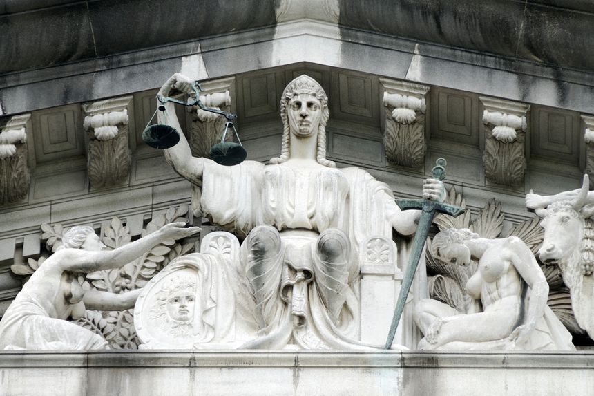 The central figure in the tympanum is that of Justice, with a figure immediately to its left representing the lost soul begging for protection from it.  Pediment sculpture of the Old Supreme Court, City hall Singapore