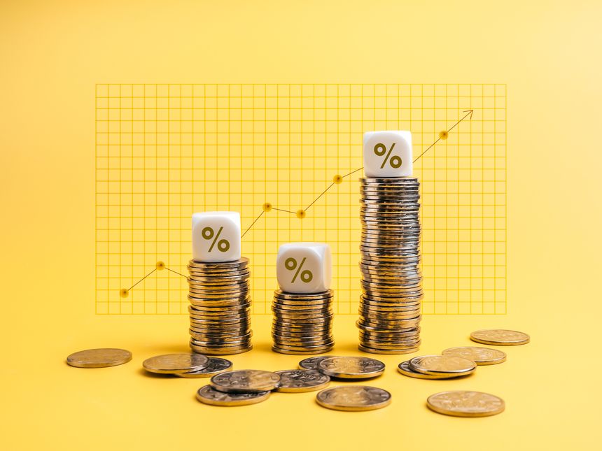 Percentage icons on white cube blocks on money coin stack as graph steps, with line chart on yellow background. Business growth, investment, profit and income, banking, economic improvement concepts.