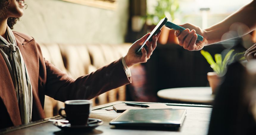 Hands, phone and payment with machine at coffee shop for order bills, drinks and easy transaction. People, waiter and customer experience with pos, smartphone and fintech app for deal at cafeteria