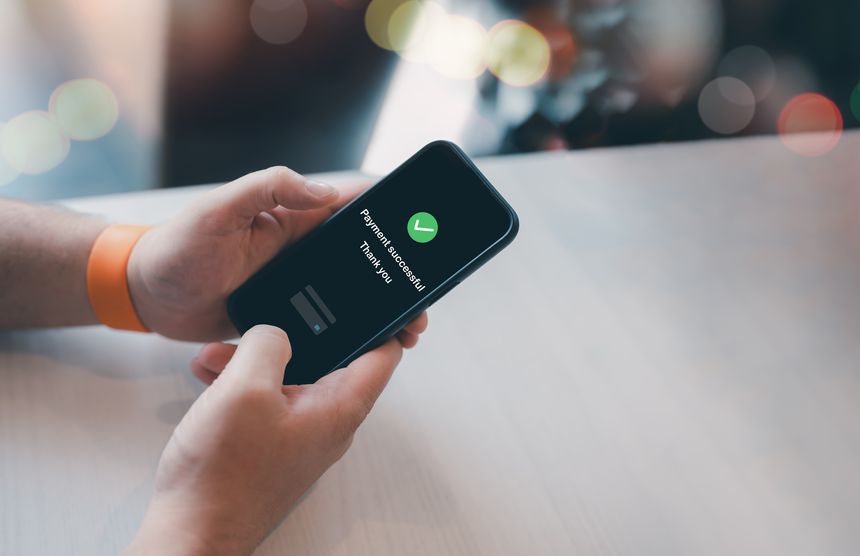 Hand holding smartphone showing successful online payment confirmation screen,Concept for mobile banking,digital business finance,secure transactions in modern fintech systems shopping online adverts