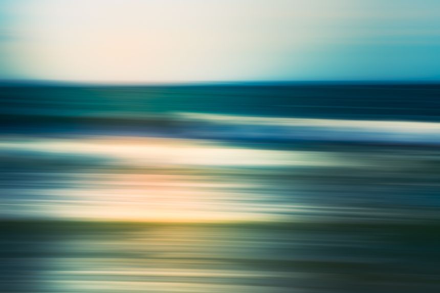 Abstract image of waves in motion with a smooth, serene seascape.