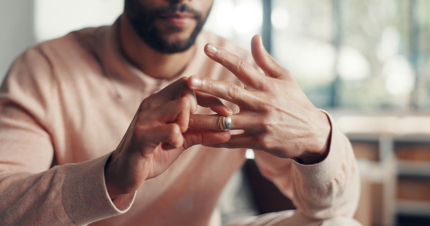 Unhappy, hands and man in home with wedding ring, divorce or issue in marriage affair. Conflict, trust and married male in living room with union band, reflection or decision of legal separation.