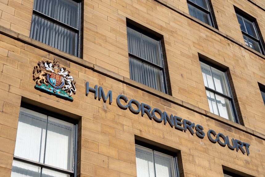 Bradford, West Yorkshire, United Kingdom - 18 March 2025 : Sign and coat of arms above HM Coroners Court in Bradford