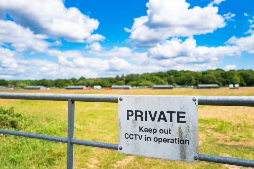 Shallow focus of a Private sign attached to a farm gate which leads to a poultry farm. CCTV is also in operation in the area.