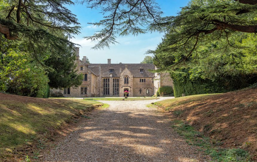 16th Century Chavenage House a Grade 1 listed building on August 8 2025, near Beaverston, Tetbury, The Cotswolds, Gloucestershire, United Kingdom. Viewed from public road.