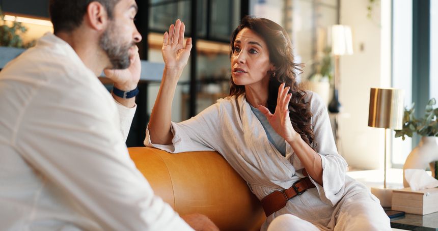 Couple, talk and arguing with fight at house for disagreement, conflict and divorce discussion. Woman, explain and bored man for conversation, toxic relationship and drama and marriage fail in lounge