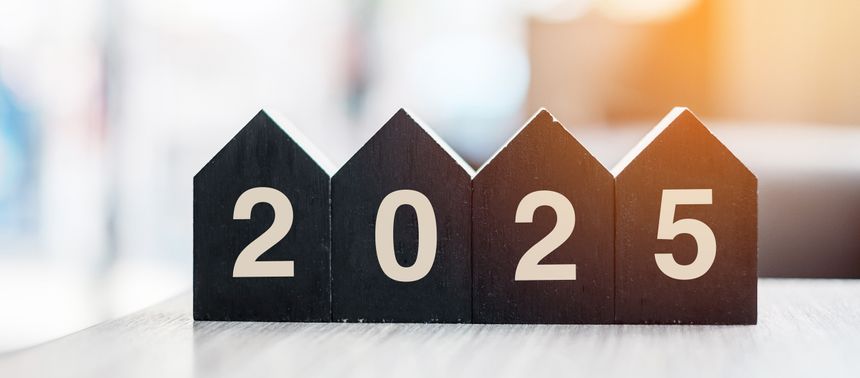 2025 Happy New Year with wooden Home model on table office. New House, Financial, Property insurance and real estate concepts