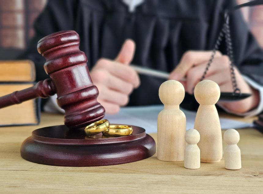 Legal proceedings with gavel, rings, and family figures in a courtroom