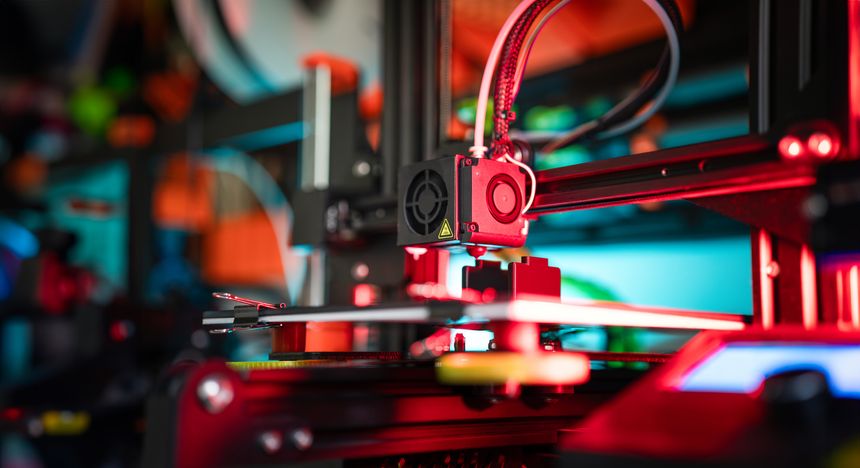 3D printer preparing object. Production prototype. Nozzle clese-up.