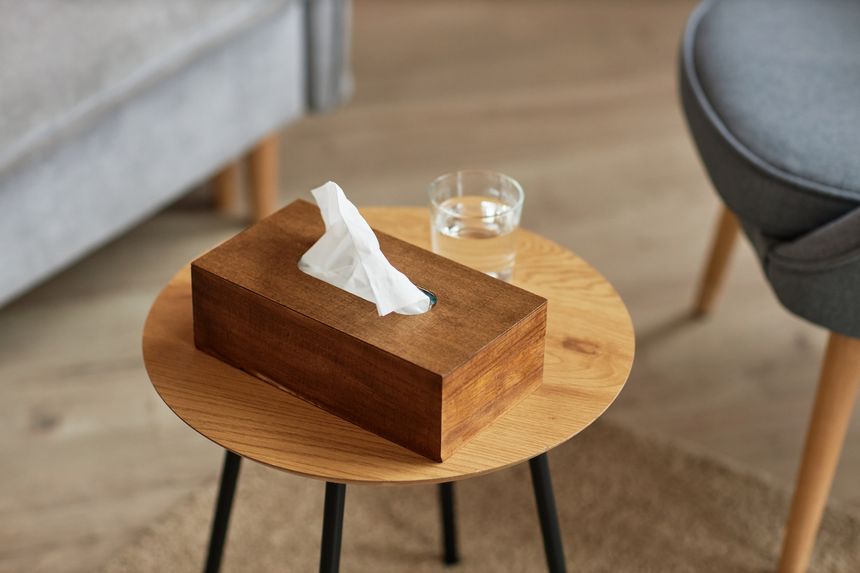 Wooden box with paper tissue and glasses of water prepared for client