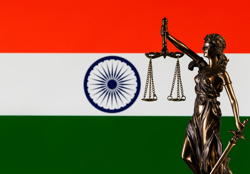 The figure of Themis against the background of the flag of the Republic of India