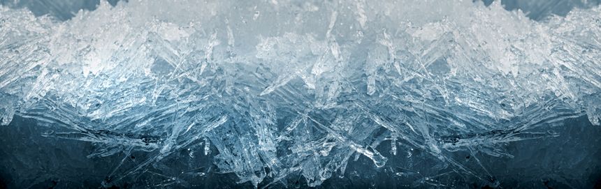 Winter snowy banner, frozen background. A scattering of large long ice crystals in the form of needles on the river in winter. Dark and Light