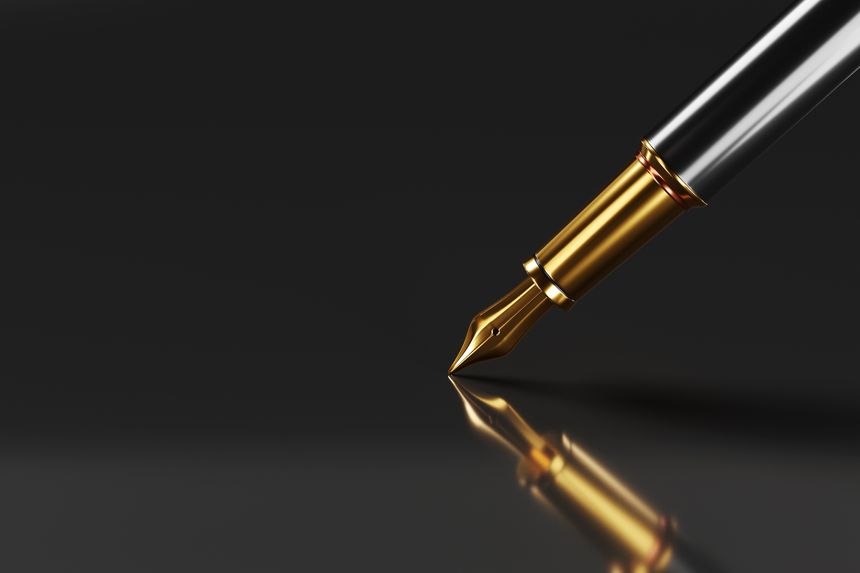Golden fountain pen being pointed down on a black reflective surface. Illustration of the concept of calligraphy, profession, business and signature