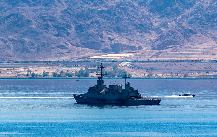 Naval military ship is moving to patrol and defense international cargo ships in the Red Sea