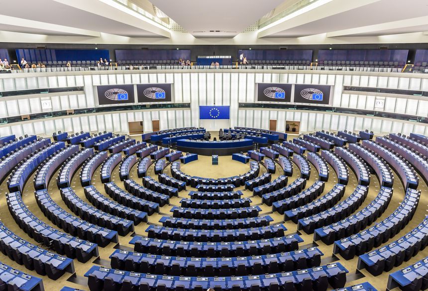 Strasbourg, France - September 13, 2019: General view of the hemicycle of the European Parliament in the Louise Weiss building with the flag of the European Union above the desk of the president.