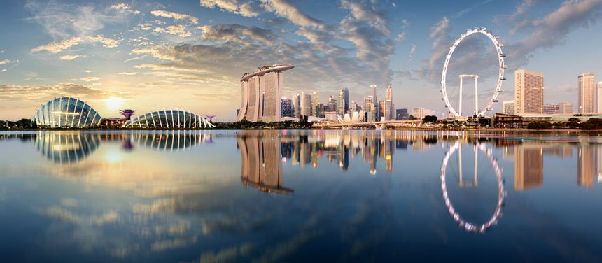 Panorama of Singapore city skyline at business modern downtown building area in sunrise with cloud and sun light and reflection architecture on water