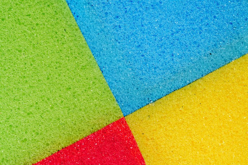 Bright Intersecting Foam Surfaces Display. Closeup Of Vivid Foam With Divided Colors. Photorealistic Depiction Of Lively Foam Surfaces Showcasing Bold Colors And Intersecting Segments For Design Use
