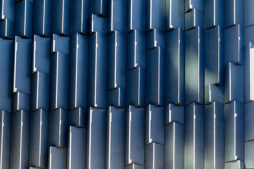 Geometric blue pattern abstract architecture design with repetitive vertical elements.