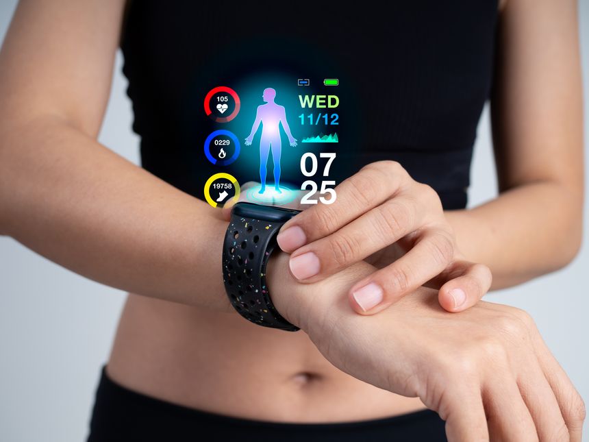 Close-up of woman in black sport bra using smart fitness watch on wrist with holographic health data display, tracking steps, heart rate, and calories. Concept of wearable technology and health care.