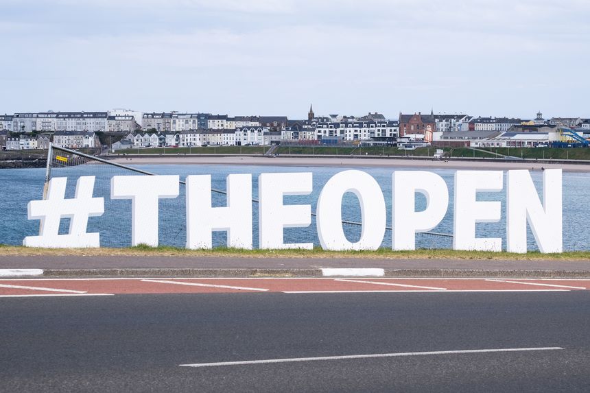 Portrush, Northern Ireland - May 19th, 2025: sign for The Open Championship Golf British Open with view of Portrush skyline, host of the 2025 sports tournament