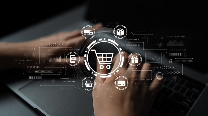 Hands engage with a laptop, displaying a digital shopping cart concept surrounded by e-commerce icons. This image captures the essence of online shopping and modern consumer interactions.