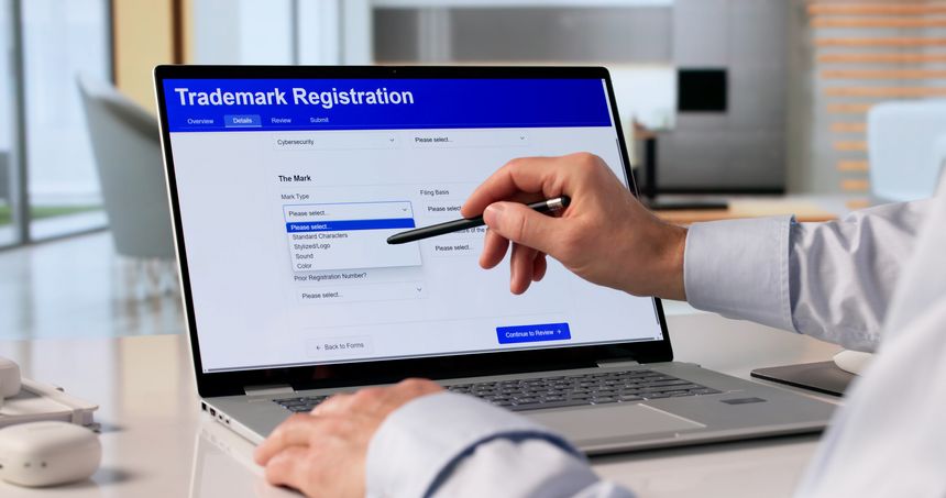 Man Using Laptop To Submit Trademark Application For Business Brand Protection.
