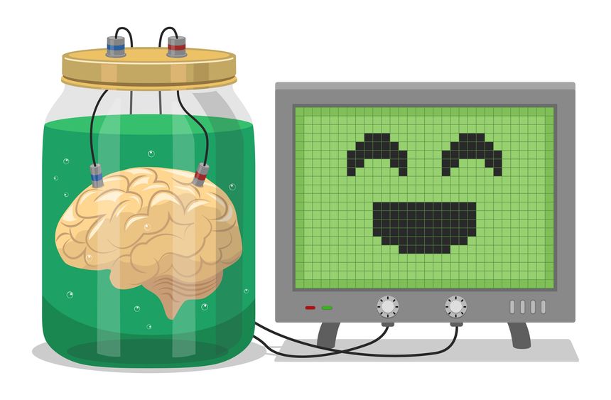A brain in a jar is wired up to a computer screen displaying a smiley face.