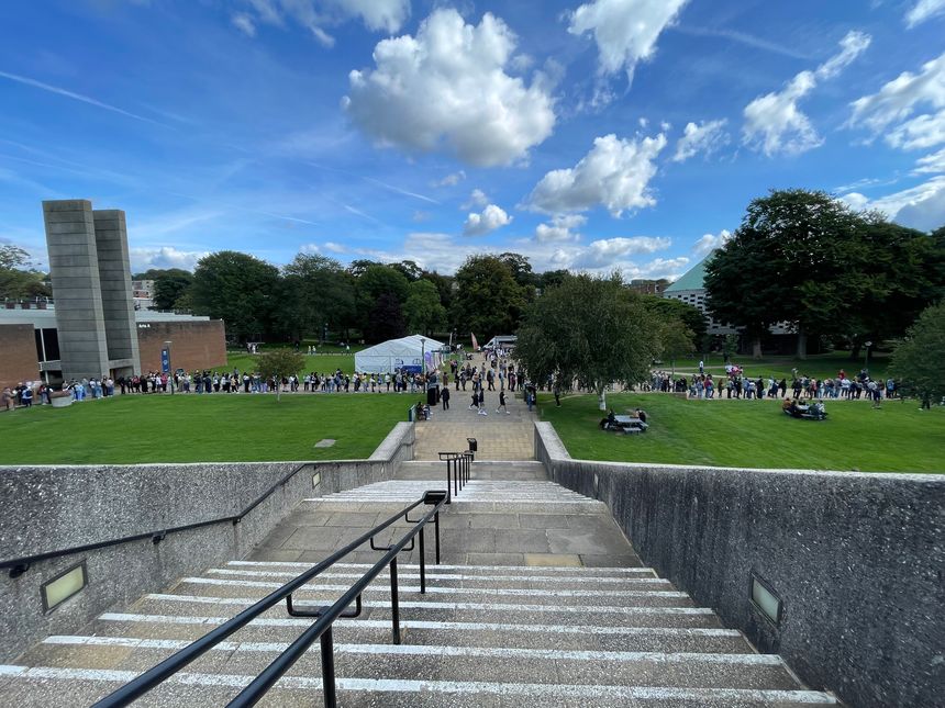 University of Sussex view from the Library steps including the Arts building and a queue of students