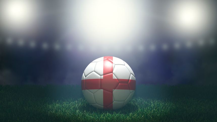 Soccer ball in flag colors on a bright blurred stadium background. England. 3D image