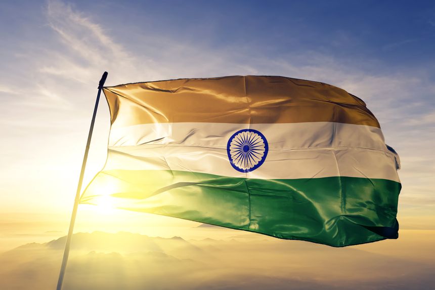 India Indian flag on flagpole textile cloth fabric waving on the top sunrise mist fog