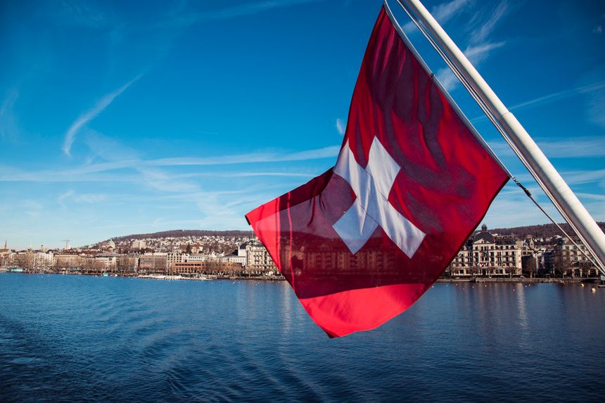 Beautiful swiss flag waving in the wind during a sailing boat trip