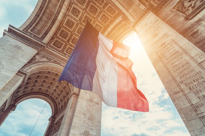 french flag at arc de triomphe during bastille day