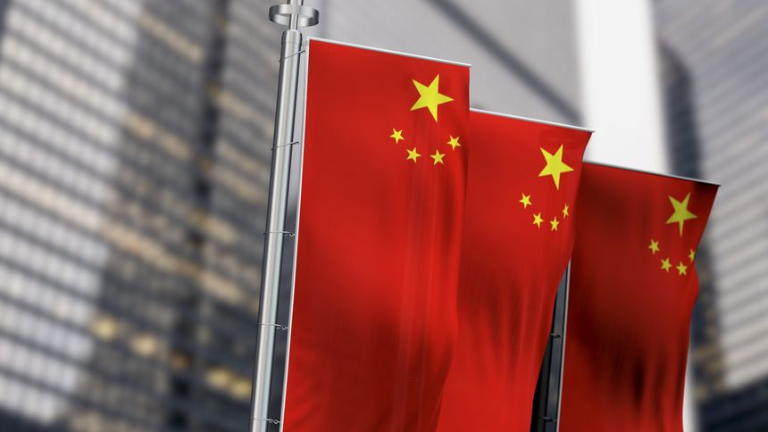 Close-up of national flag of China waving in the wind. Red background, five yellow stars. The largest symbolizes the guidance of the Chinese Communist Party. 3D illustration render. Rippled fabric