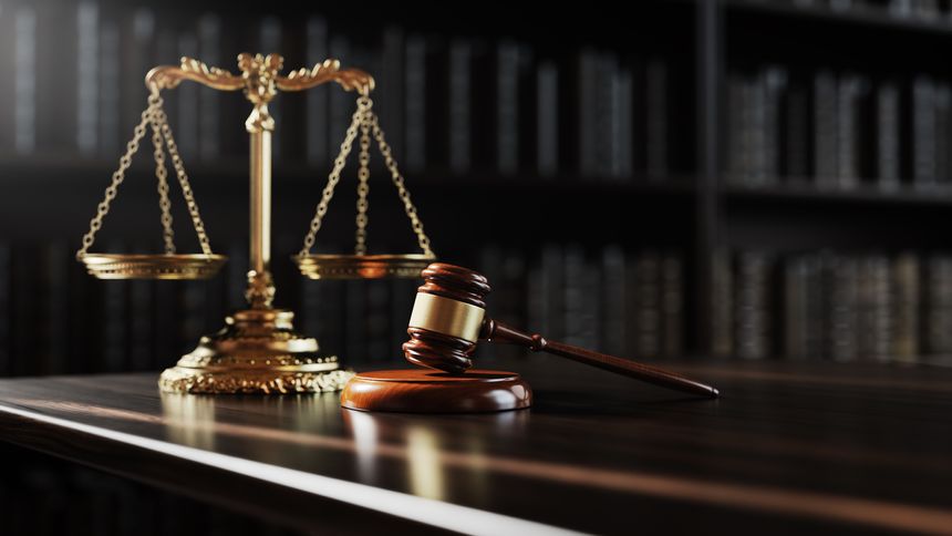 Legal concept: Scales of justice and and the judge's gavel hammer as a symbol of law and order on the background of books.