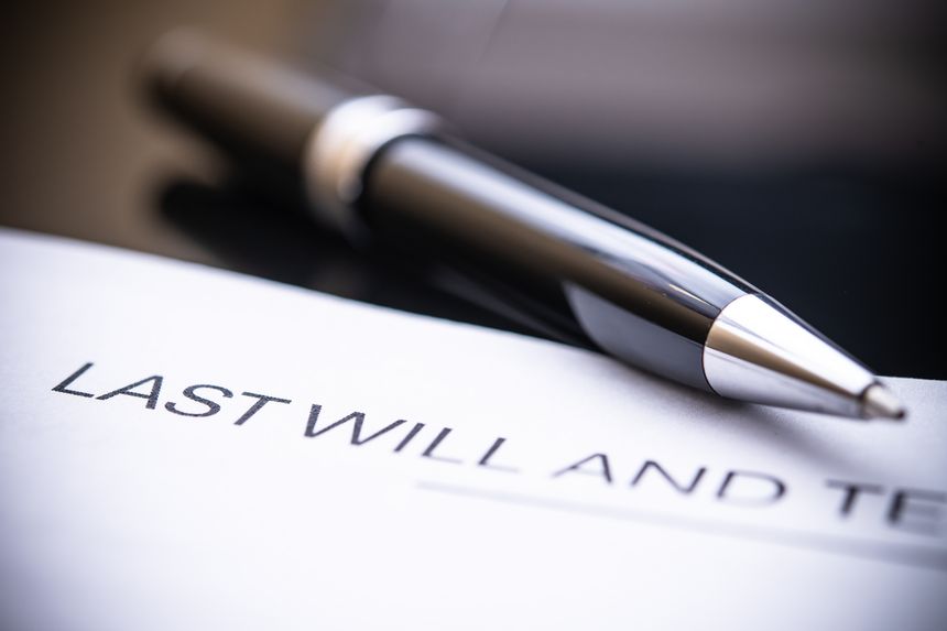 A close-up view of a last will and testament document accompanied by a sleek pen, symbolizing legal affairs, estate planning, and personal legacy management.