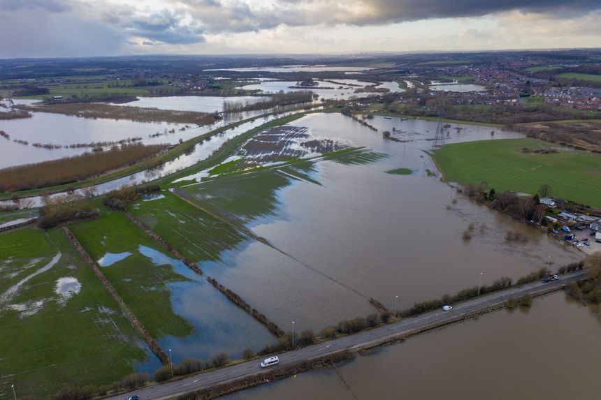 Aerial drone photo of the town of Allerton Bywater near Castleford in Leeds West Yorkshire showing the flooded fields from the River Aire on a rainy winters day during a large flood after a storm.
