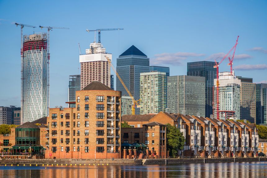 New development apartments in Canary Wharf seen from Greenland Dock in London, UK