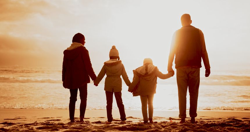 Holding hands, sunset and back of family by beach on vacation, getaway or holiday for bonding. Evening, love and parents with children for connection by ocean for tropical weekend trip