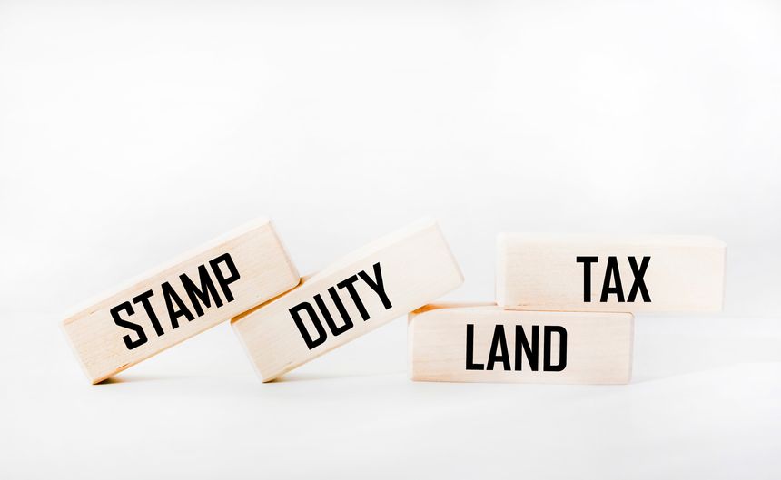 SDLT - Stamp duty, land tax, written on blocks on a white background