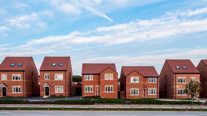 A row of new build detached homes on a construction site for the UK Government's Right To Buy scheme with sold sign