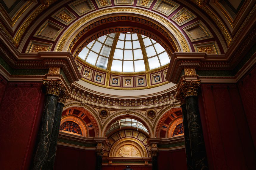 The grand domed ceiling interior of the National Gallery at Trafalgar Square, London, with a glass skylight and traditional 19th-century Greek Revival architecture.