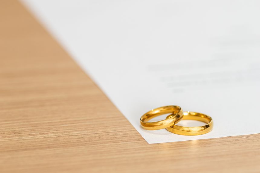 Divorce, rings and paperwork for a lawyer, register wedding with copu space. Table, closeup and a certificate, planning or legal documrnts for a commitment or engagement