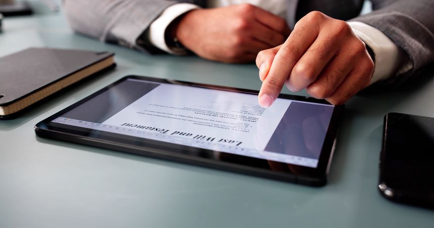 Man signs digital last will online, ensuring legal documentation recorded.