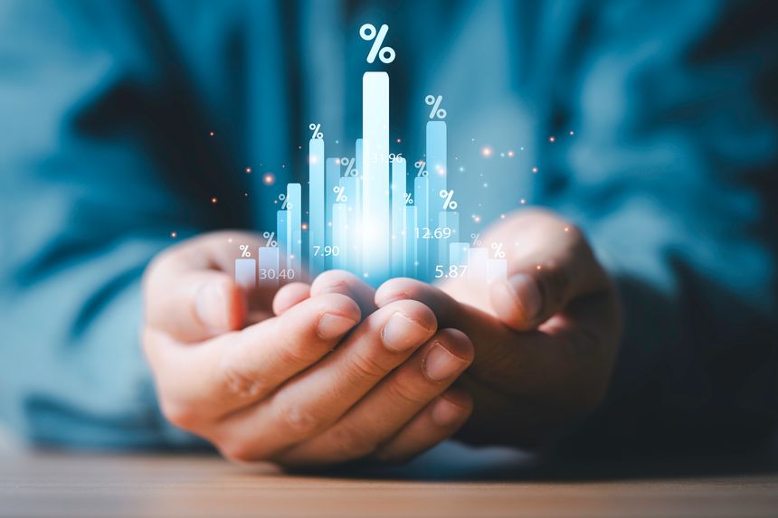 Businessman holding glowing increasing graph chart with percentage for financial banking interest and company business growth concept.