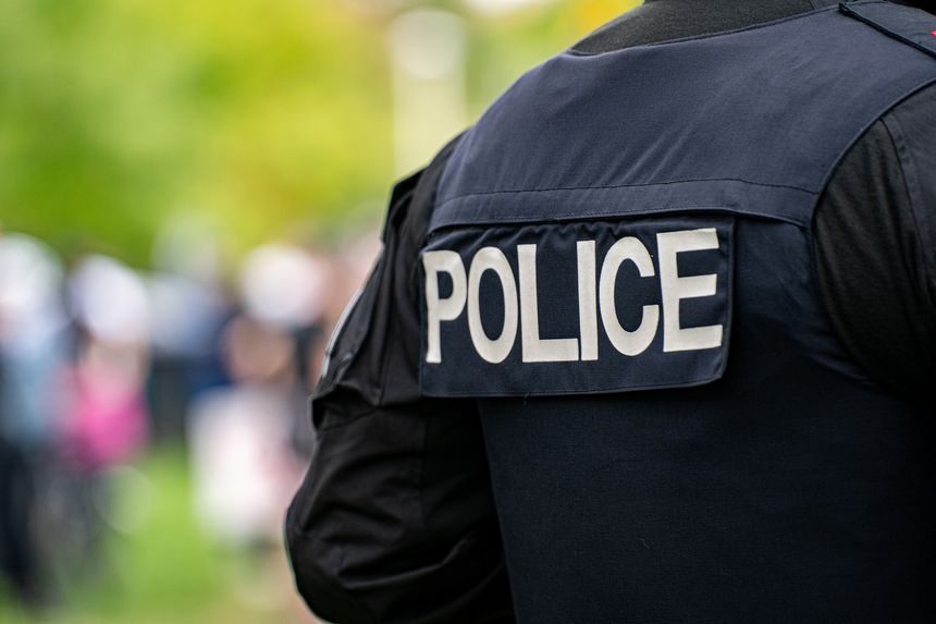 Back view of police uniform with label.