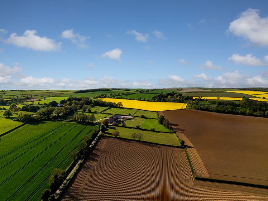 The farmers fields look stunning in Springtime, with the bright yellow rapeseed , contrasting with the newly ploughed brown earth in neat rows, and green fields. Drone Point of view