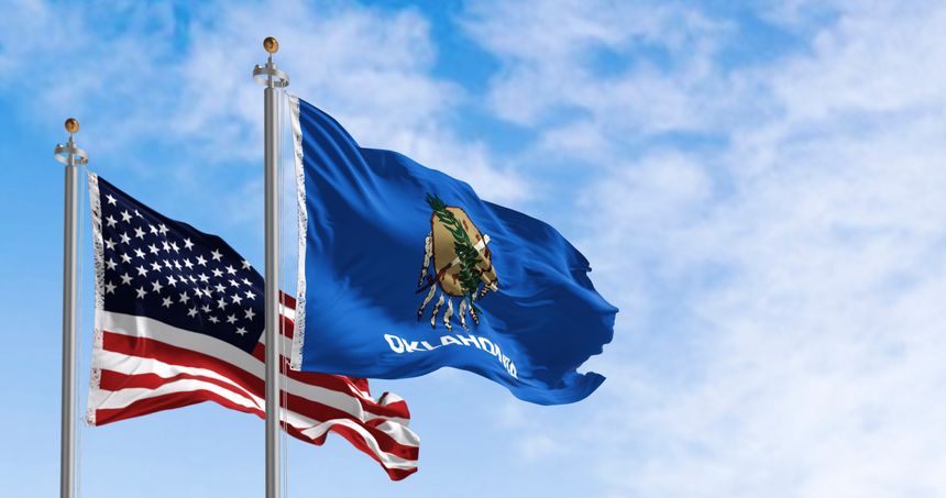 Oklahoma and USA flags waving together. Concept of state and federal identity, with Native American heritage. 3D render.