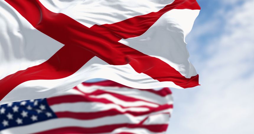 United States and Alabama flags waving together on a sunny day. The flag of Alabama features a red cross on a white field. 3d illustration render, Fluttering fabric. Selective focus