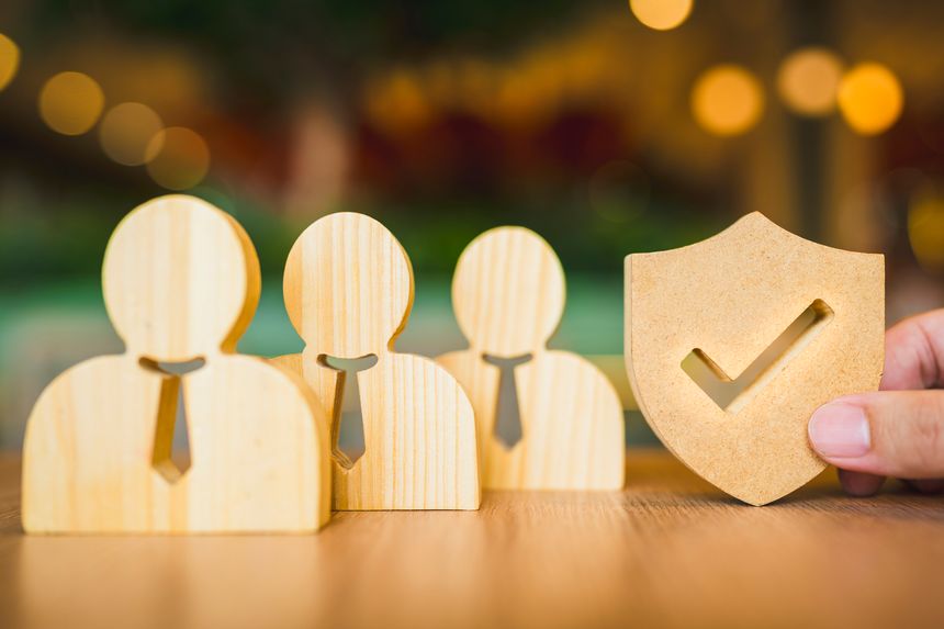 Shield icon and people model. Security protection and group  insurance. The concept of family home, protection, health care day, car insurance.